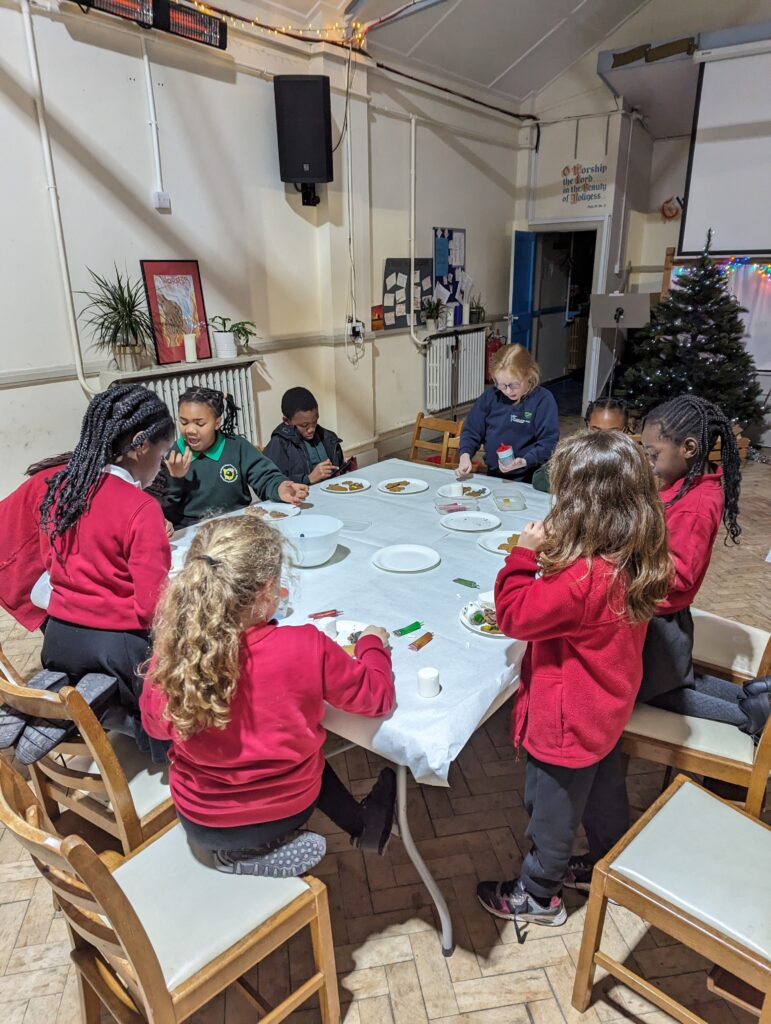 A group of children decorating biscuits